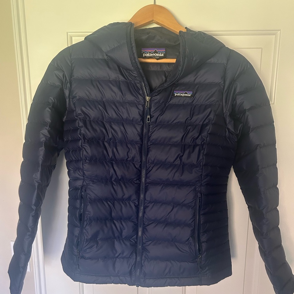 Patagonia women’s lightweight insulated puffer jacket with hood.